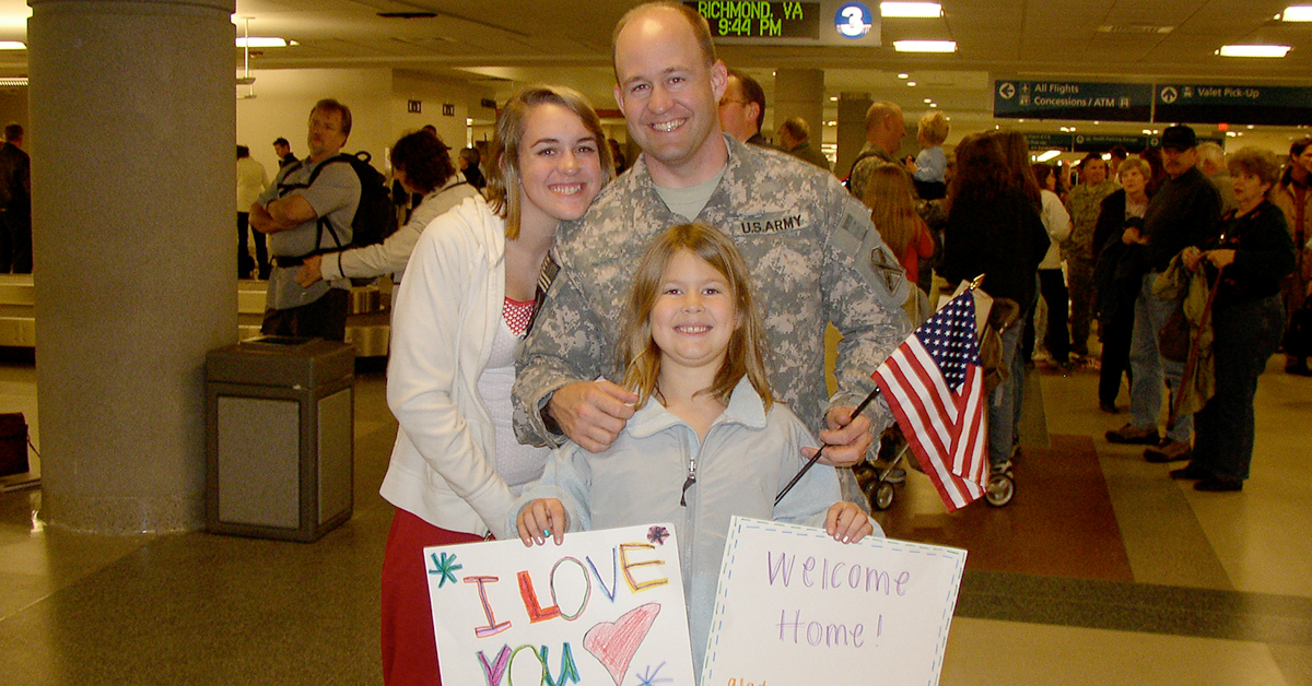 Chris, a Tech leader at Capital One, is welcomed home by his family in the airport in his digis after a long Afghanistani deployment